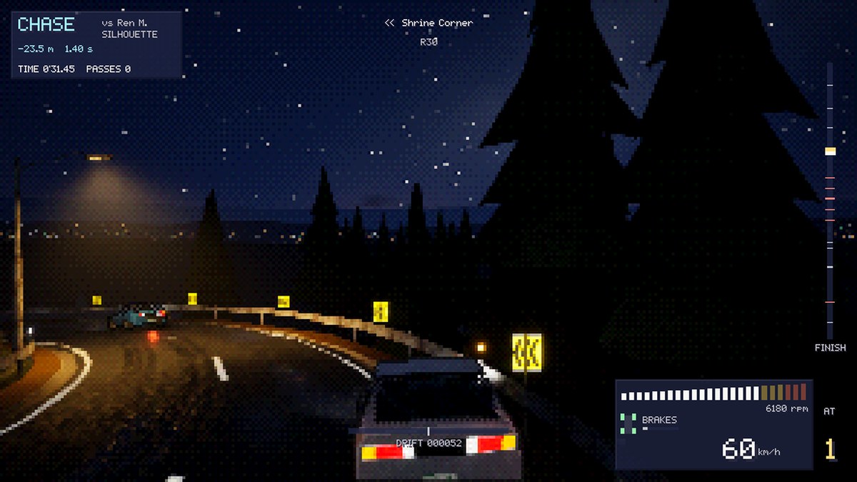 Chase camera behind the hatchback at night, the rival ahead at Shrine Corner under a streetlamp